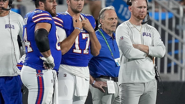 Aug 26, 2022; Charlotte, North Carolina, USA; Buffalo Bills guard Greg Van Roten (64), quarterback Josh Allen (17) and offensive coach Joe Brady watch as Carolina Panthers quarterback Sam Darnold (not pictured) is carted off the field during the second half at Bank of America Stadium. Mandatory Credit: Jim Dedmon-USA TODAY Sports