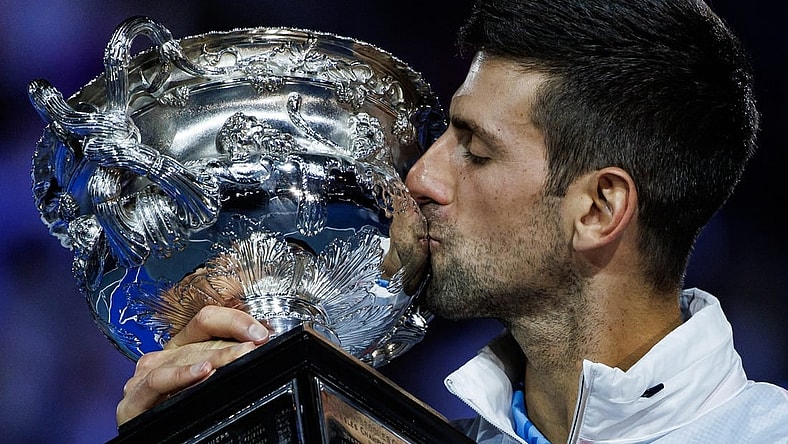Jan 29, 2023; Melbourne, Victoria, Australia; Novak Djokovic of Serbia celebrates with the trophy after his victory over Stefanos Tsitsipas of Greece in the men's final on day fourteen of the 2023 Australian Open tennis tournament at Melbourne Park. Mandatory Credit: Mike Frey-USA TODAY Sports