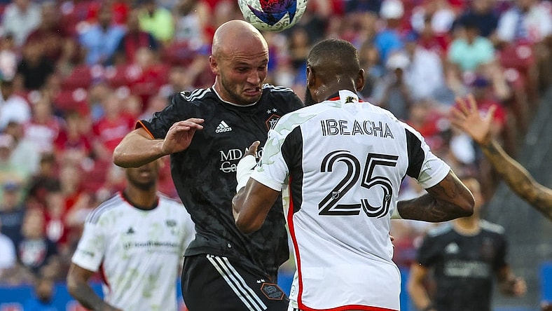 May 20, 2023; Frisco, Texas, USA; Houston Dynamo defender Chase Gasper (30) heads the ball in front of FC Dallas defender Sebastien Ibeagha (25) during the first half at Toyota Stadium. Mandatory Credit: Kevin Jairaj-USA TODAY Sports
