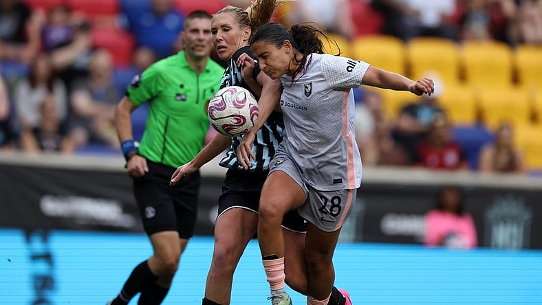 Jul 2, 2023; Harrison, New Jersey, USA; Angel City FC midfielder Lily Nabet (28) goes for the ball during the second half against New Jersey/New York Gotham FC midfielder Allie Long (6) at Red Bull Arena. Mandatory Credit: Vincent Carchietta-USA TODAY Sports
