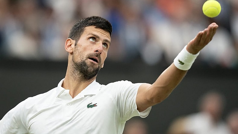 Jul 14, 2023; London, United Kingdom; Novak Djokovic (SRB) tosses the ball to serve during his match against Jannik Sinner (ITA) on day 12 at the All England Lawn Tennis and Croquet Club.  Mandatory Credit: Susan Mullane-USA TODAY Sports
