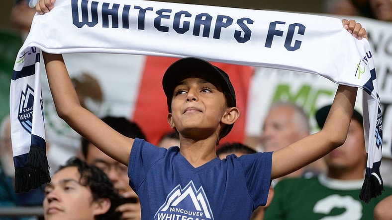Jul 21, 2023; Vancouver, British Columbia, CAN; A young Vancouver Whitecaps fan is seen holding a scarf during the second half between the Vancouver Whitecaps and Club Leon at BC Place. Mandatory Credit: Anne-Marie Sorvin-USA TODAY Sports