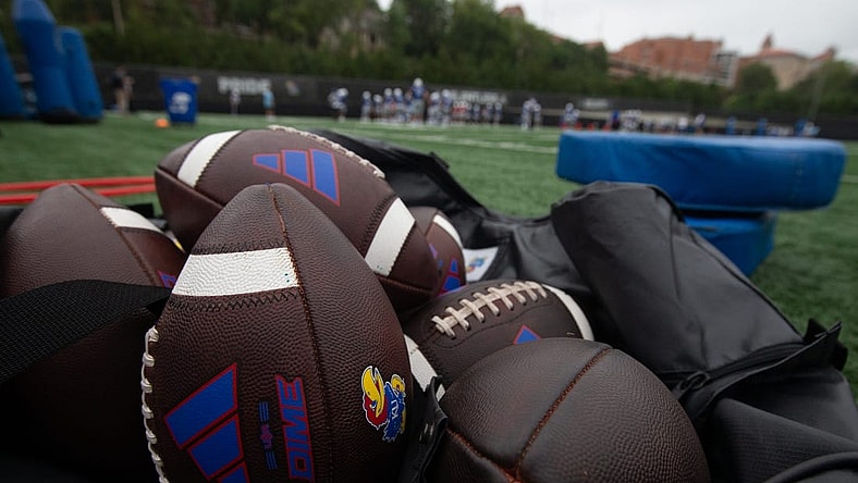 Kansas practice footballs are seen in an equipment bag at Monday's practice.