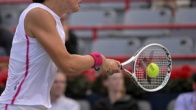 Aug 11, 2023; Montreal, Quebec, Canada; Iga Swiatek (POL) hits a backhand against Danielle Collins (USA) (not pictured) during quarterfinal play at IGA Stadium. Mandatory Credit: Eric Bolte-USA TODAY Sports