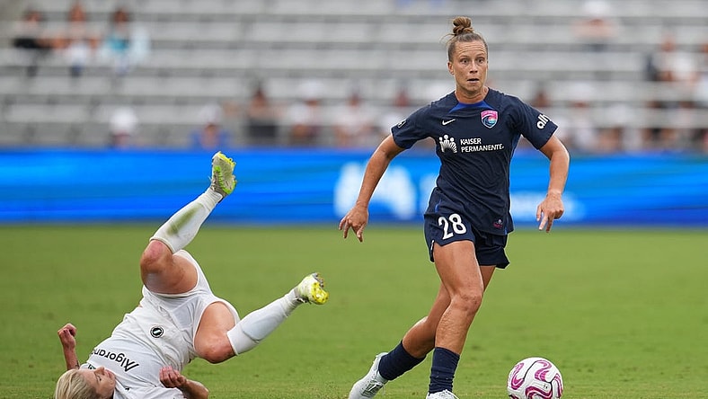 Aug 19, 2023; San Diego, California, USA; San Diego Wave FC midfielder Meggie Dougherty Howard (28) dribbles past NJ/NY Gotham FC midfielder Jenna Nighswonger (32) during the first half at Snapdragon Stadium. Mandatory Credit: Ray Acevedo-USA TODAY Sports