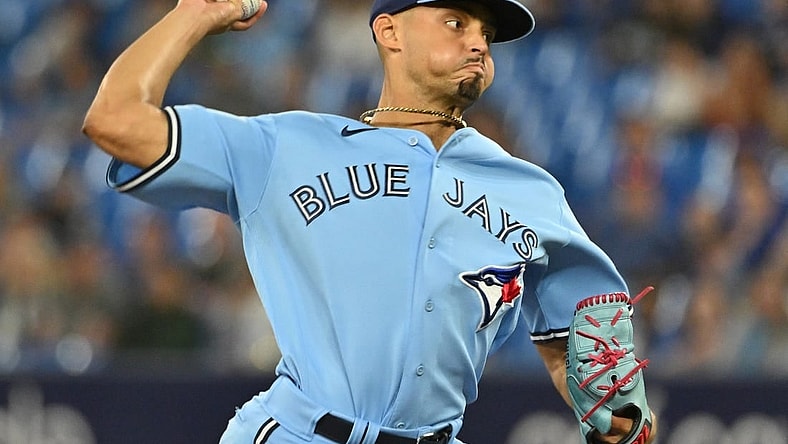 Aug 28, 2023; Toronto, Ontario, CAN;  Toronto Blue Jays relief pitcher Jordan Hicks (12) delivers a pitch against the Washington Nationals in the ninth inning at Rogers Centre. Mandatory Credit: Dan Hamilton-USA TODAY Sports