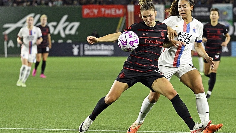 Sep 16, 2023; Portland, Oregon, USA; Portland Thorns FC defender Natalia Kuikka (14) moves the ball against OL Reign midfielder Angelina (6) at Providence Park. Mandatory Credit: Troy Wayrynen-USA TODAY Sports