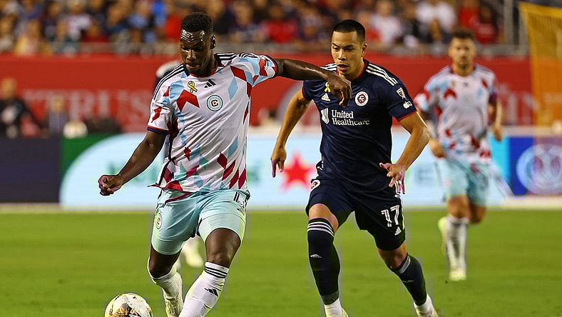 Sep 23, 2023; Chicago, Illinois, USA; Chicago Fire defender Carlos Teran (4) steals the ball from New England Revolution forward Bobby Wood (17) from during the second half at Soldier Field. Mandatory Credit: Mike Dinovo-USA TODAY Sports