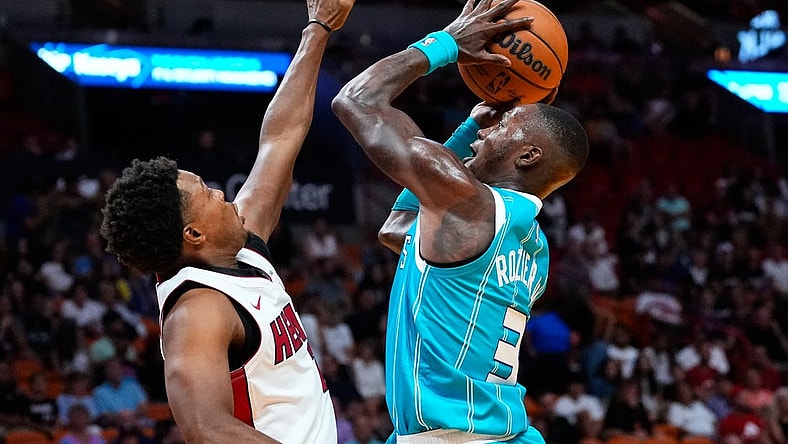 Oct 10, 2023; Miami, Florida, USA; Charlotte Hornets guard Terry Rozier (3) shoots over Miami Heat guard Kyle Lowry (7) during the first quarter at Kaseya Center. Mandatory Credit: Rich Storry-USA TODAY Sports