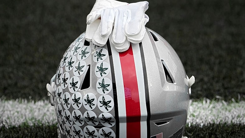 Oct. 14, 2023; Lafayette, In., USA; 
Gloves lie on top of the helmet of Ohio State Buckeyes wide receiver Julian Fleming (4) before Saturday's NCAA Division I football game against the Purdue Boilermakers at Ross-Ade Stadium in Lafayette.