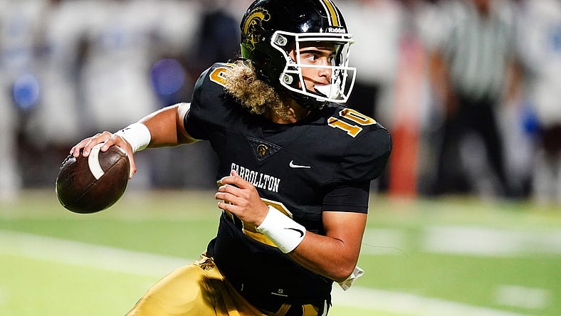 Oct 20, 2023; Carrollton, GA, USA; Carrollton Trojans quarterback Julian Lewis (10) scrambles out of the pocket against the Westlake Lions during the first half at Grisham Stadium. The 15-year-old Carrollton High student has already committed to playing for the University of Southern California Trojans and has been considered one of the top high school quarterback prospects. Mandatory Credit: John David Mercer-USA TODAY Sports