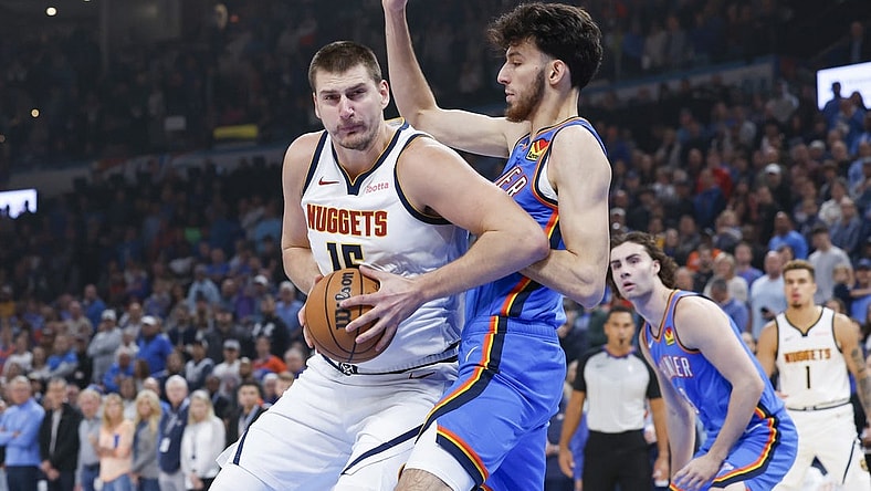 Oct 29, 2023; Oklahoma City, Oklahoma, USA; Denver Nuggets center Nikola Jokic (15) drives to the basket against Oklahoma City Thunder forward Chet Holmgren (7) during the first quarter at Paycom Center. Mandatory Credit: Alonzo Adams-USA TODAY Sports