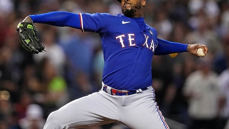 Texas Rangers relief pitcher Aroldis Chapman (45) pitches during the seventh inning against the Arizona Diamondbacks during game five of the 2023 World Series at Chase Field.