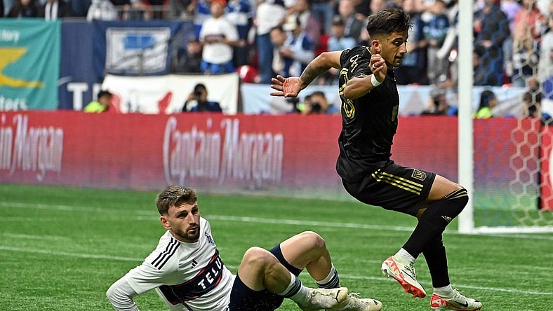Nov 5, 2023; Vancouver, British Columbia, CAN; Vancouver Whitecaps defender Tristan Blackmon (6) tackles the ball away from Los Angeles FC forward Cristian Olivera (25) during the second half of game two in a round one match of the 2023 MLS Cup Playoffs at BC Place. Mandatory Credit: Simon Fearn-USA TODAY Sports