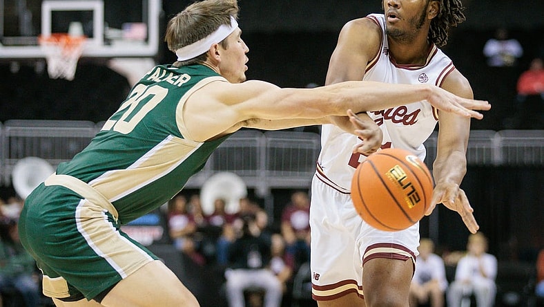Nov 22, 2023; Kansas City, Missouri, USA; Boston College Eagles forward Devin McGlockton (21) passes the ball around Colorado State Rams guard Joe Palmer (20) during the first half at T-Mobile Center. Mandatory Credit: William Purnell-USA TODAY Sports