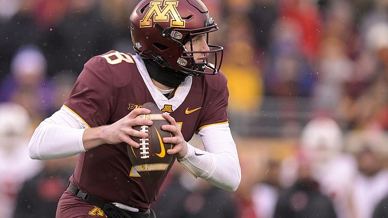 Nov 25, 2023; Minneapolis, Minnesota, USA;  Minnesota Golden Gophers quarterback Athan Kaliakmanis (8) scrambles out of the pocket against the Wisconsin Badgers during the second quarter at Huntington Bank Stadium. Mandatory Credit: Nick Wosika-USA TODAY Sports