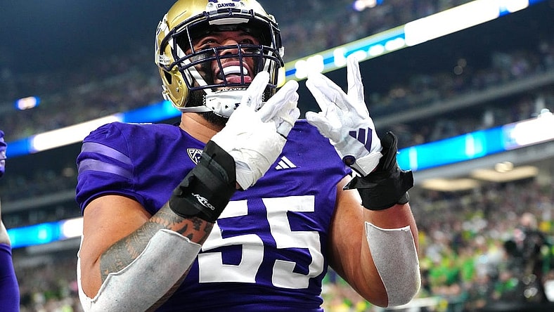 Dec 1, 2023; Las Vegas, NV, USA; Washington Huskies offensive lineman Troy Fautanu (55) celebrates after the Huskies scored against the Oregon Ducks during the first quarter at Allegiant Stadium. Mandatory Credit: Stephen R. Sylvanie-USA TODAY Sports
