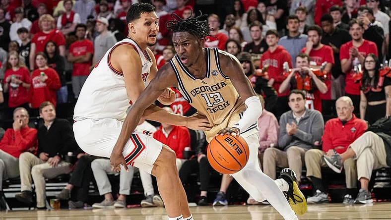 Dec 5, 2023; Athens, Georgia, USA; Georgia Tech Yellow Jackets guard Miles Kelly (13) dribbles against Georgia Bulldogs guard RJ Melendez (15) during the second half at Stegeman Coliseum. Mandatory Credit: Dale Zanine-USA TODAY Sports