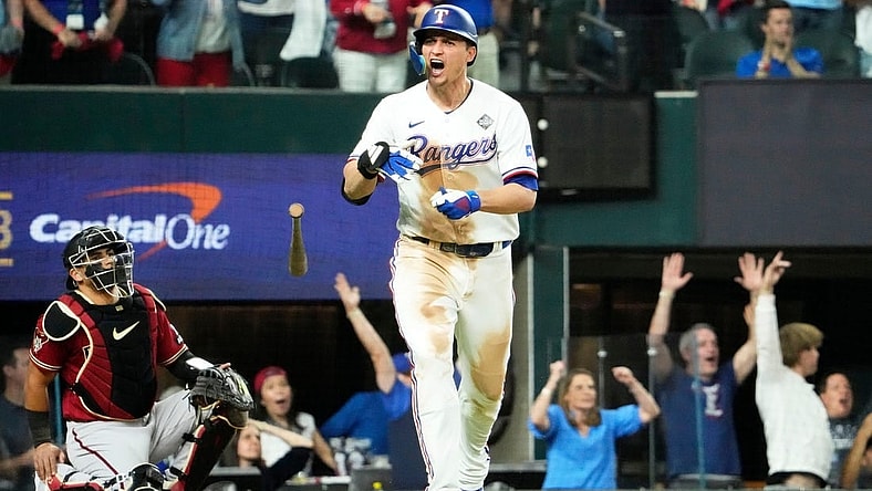 Texas Rangers Corey Seager (5) hits a two-run home run off Arizona Diamondbacks relief pitcher Paul Sewald (38) in the ninth inning during Game 1 of the 2023 World Series at Globe Life Field on Oct 27, 2023.