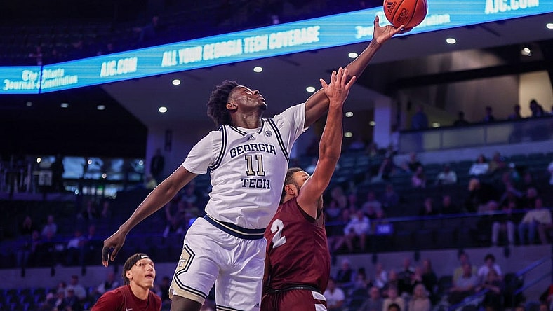 Dec 9, 2023; Atlanta, Georgia, USA; Georgia Tech Yellow Jackets forward Baye Ndongo (11) reaches for a rebound over Alabama A&M Bulldogs guard Omari Peek (2) in the first half at McCamish Pavilion. Mandatory Credit: Brett Davis-USA TODAY Sports