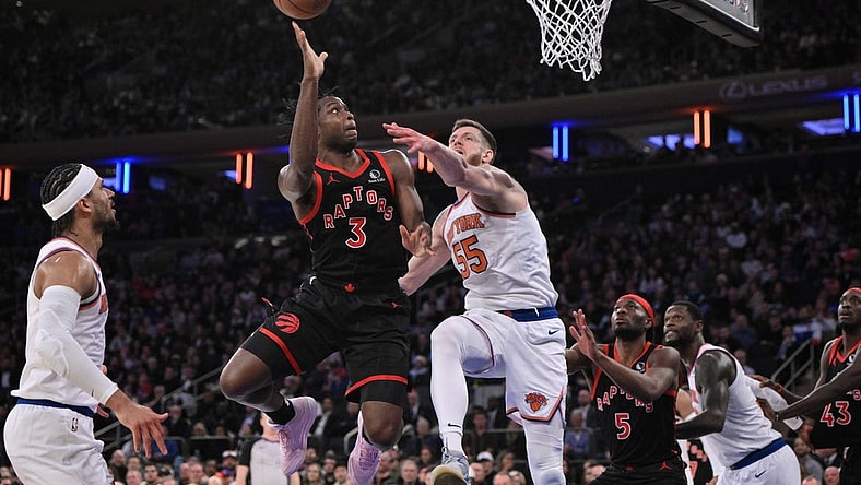 Dec 11, 2023; New York, New York, USA; Toronto Raptors forward O.G. Anunoby (3) shoots the ball while being defended by New York Knicks center Isaiah Hartenstein (55) during the fourth quarter at Madison Square Garden. Mandatory Credit: John Jones-USA TODAY Sports