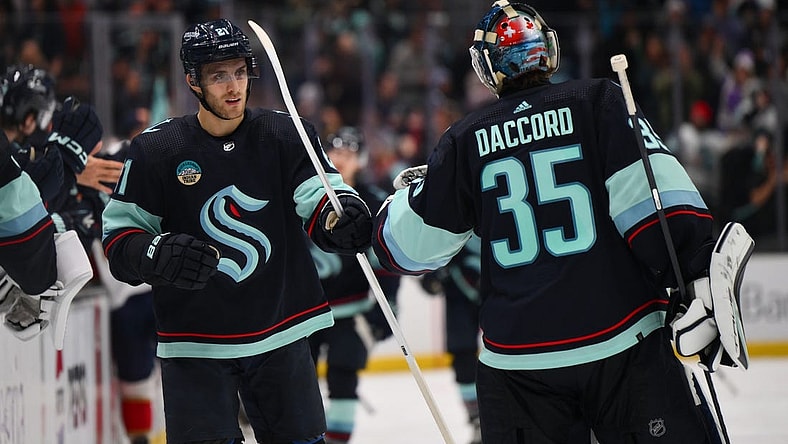 Dec 12, 2023; Seattle, Washington, USA; Seattle Kraken center Alex Wennberg (21) and goaltender Joey Daccord (35) celebrate after Wennberg scored a goal against the Florida Panthers during the third period at Climate Pledge Arena. Mandatory Credit: Steven Bisig-USA TODAY Sports