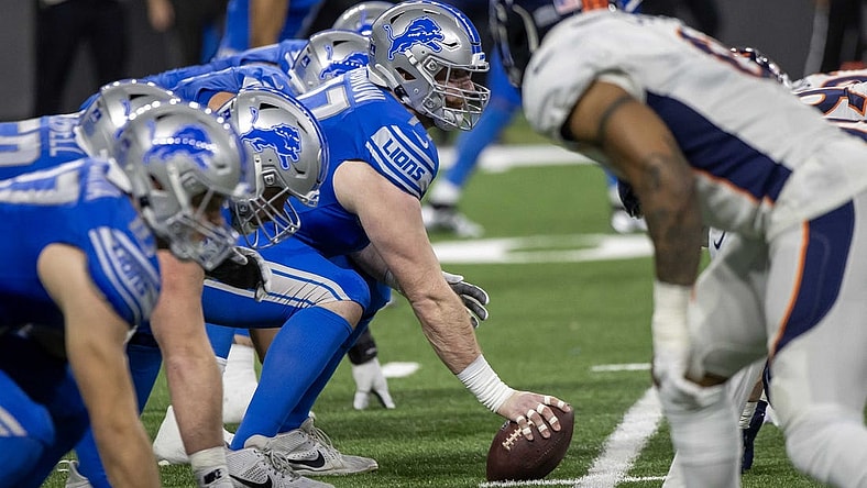 Dec 16, 2023; Detroit, Michigan, USA; Detroit Lions center Frank Ragnow (77) gets ready to snap the ball in the first half against the Denver Broncos at Ford Field. Mandatory Credit: David Reginek-USA TODAY Sports