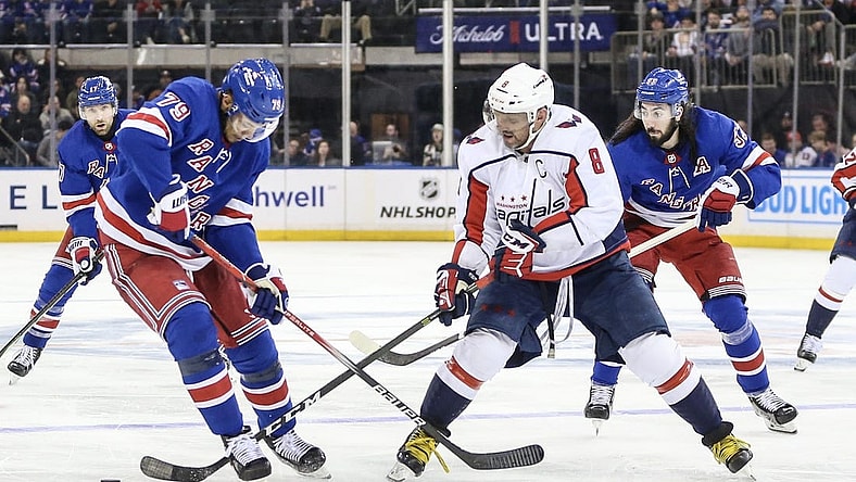Dec 27, 2023; New York, New York, USA; New York Rangers defenseman K'Andre Miller (79) and Washington Capitals left wing Alex Ovechkin (8) battle for control of the puck in the third period at Madison Square Garden. Mandatory Credit: Wendell Cruz-USA TODAY Sports