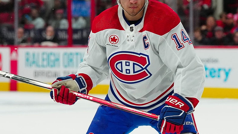 Dec 28, 2023; Raleigh, North Carolina, USA; Montreal Canadiens center Nick Suzuki (14) watches the play against the Carolina Hurricanes during the second period at PNC Arena. Mandatory Credit: James Guillory-USA TODAY Sports