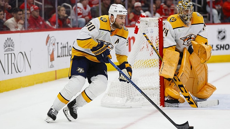 Dec 29, 2023; Detroit, Michigan, USA; Nashville Predators center Ryan O'Reilly (90) handles the puck during an overtime period of the game between the Detroit Red Wings and the Nashville Predators at Little Caesars Arena. Mandatory Credit: Brian Bradshaw Sevald-USA TODAY Sports