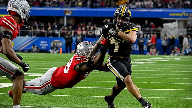 Dec 29, 2023; Arlington, TX, USA; Missouri Tigers running back Cody Schrader (7) runs for a first down against the Ohio State Buckeyes during the fourth quarter at AT&T Stadium. Mandatory Credit: Jerome Miron-USA TODAY Sports