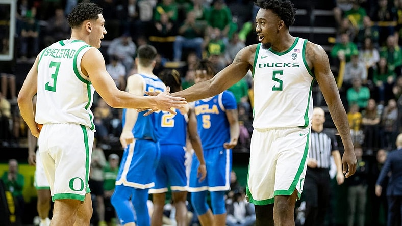 Oregon guard Jermaine Couisnard and Oregon guard Jackson Shelstad celebrate in the second half as the Oregon Ducks host the UCLA Bruins Saturday, Dec. 30, 2023, at Matthew Knight Arena in Eugene, Ore.