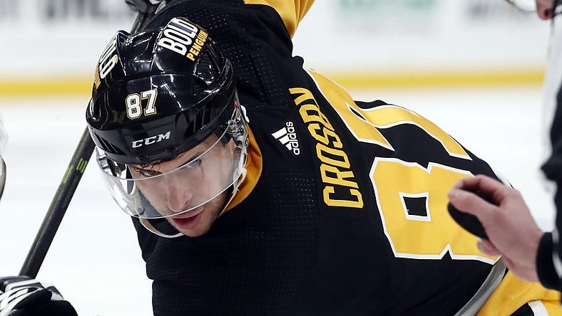 Dec 30, 2023; Pittsburgh, Pennsylvania, USA; Pittsburgh Penguins center Sidney Crosby (87) eyes the puck on a face-off against the St. Louis Blues during the first period at PPG Paints Arena. Mandatory Credit: Charles LeClaire-USA TODAY Sports