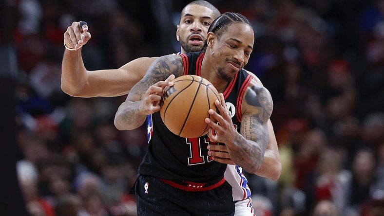 Dec 30, 2023; Chicago, Illinois, USA; Philadelphia 76ers forward Nicolas Batum (40) defends against Chicago Bulls forward DeMar DeRozan (11) during the second half at United Center. Mandatory Credit: Kamil Krzaczynski-USA TODAY Sports