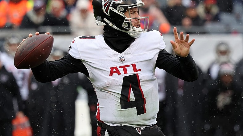 Dec 31, 2023; Chicago, Illinois, USA; Atlanta Falcons quarterback Taylor Heinicke (4) drops back to pass against the Chicago Bears during the first half at Soldier Field. Mandatory Credit: Mike Dinovo-USA TODAY Sports