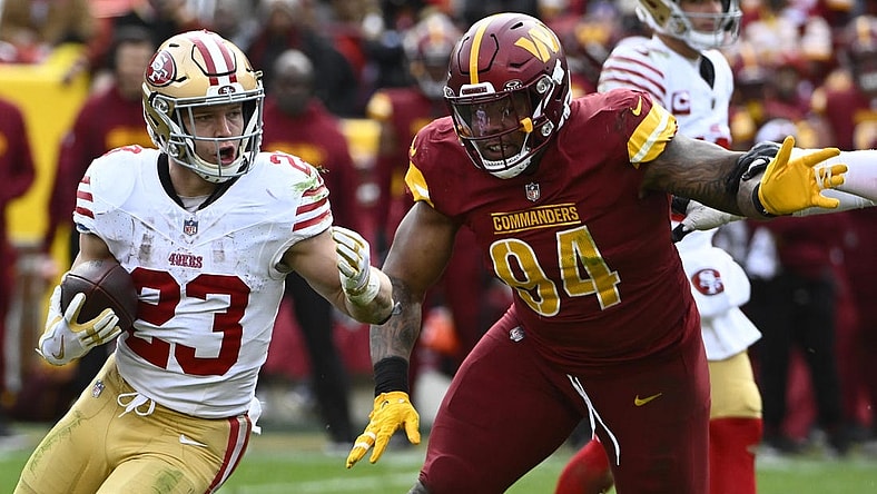 Dec 31, 2023; Landover, Maryland, USA; San Francisco 49ers running back Christian McCaffrey (23) carries the ball as Washington Commanders defensive tackle Daron Payne (94) during the second half at FedExField. Mandatory Credit: Brad Mills-USA TODAY Sports