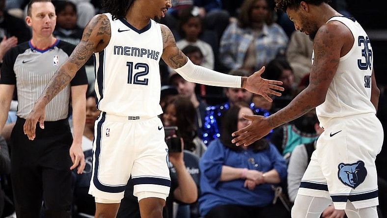 Dec 31, 2023; Memphis, Tennessee, USA; Memphis Grizzlies guard Ja Morant (12) reacts with guard Marcus Smart (36) during the second half against the Sacramento Kings at FedExForum. Mandatory Credit: Petre Thomas-USA TODAY Sports