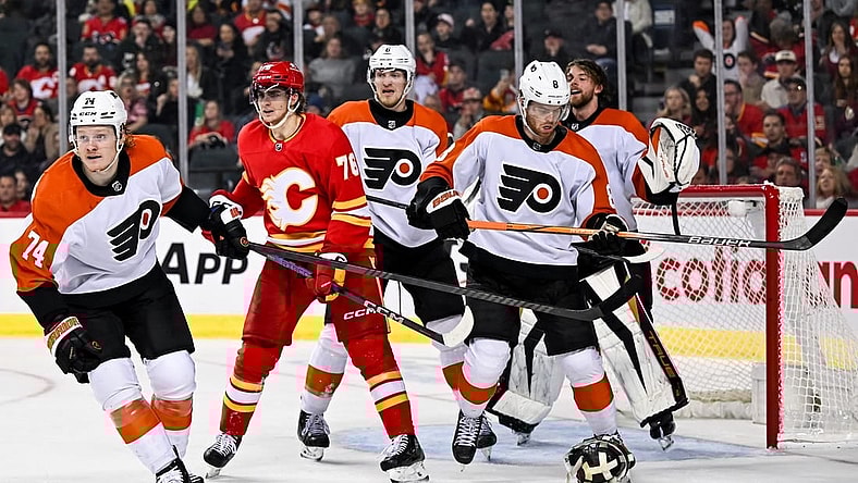Dec 31, 2023; Calgary, Alberta, CAN; Philadelphia Flyers goaltender Samuel Ersson (33) pulls off his mask during the third period in a game against the Calgary Flames at Scotiabank Saddledome. Mandatory Credit: Brett Holmes-USA TODAY Sports