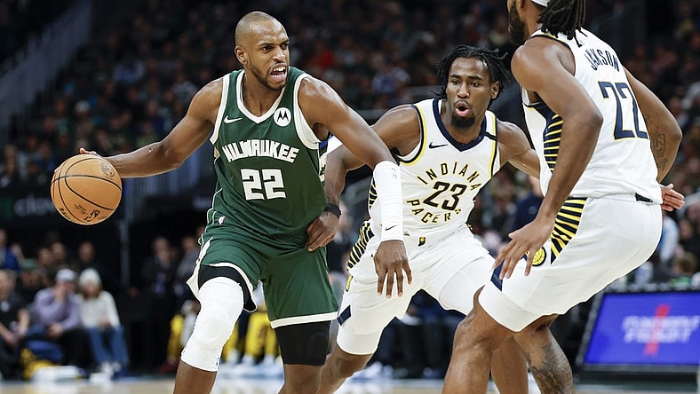 Jan 1, 2024; Milwaukee, Wisconsin, USA; Milwaukee Bucks forward Khris Middleton (22) drives to the basket against Indiana Pacers forward Isaiah Jackson (22) during the first half at Fiserv Forum. Mandatory Credit: Kamil Krzaczynski-USA TODAY Sports