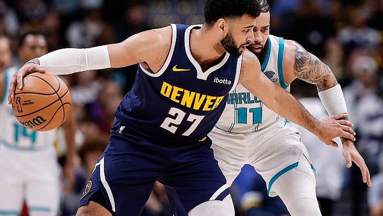 Jan 1, 2024; Denver, Colorado, USA; Denver Nuggets guard Jamal Murray (27) controls the ball against Charlotte Hornets forward Cody Martin (11) in the second quarter at Ball Arena. Mandatory Credit: Isaiah J. Downing-USA TODAY Sports