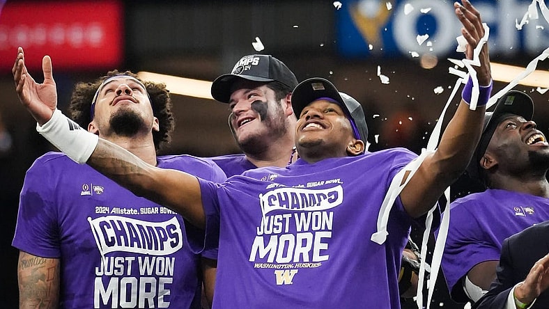 Washington Huskies quarterback Michael Penix Jr. (9), center, and his teammates watch as confetti begins to fall after winning the Sugar Bowl College Football Playoff semi-finals at the Ceasars Superdome in New Orleans, Louisiana, Jan. 1, 2024. The Huskies won the game over the Texas Longhorns 37-31.