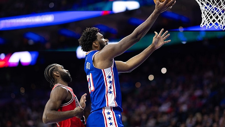 Jan 2, 2024; Philadelphia, Pennsylvania, USA; Philadelphia 76ers center Joel Embiid (21) drives for a score past Chicago Bulls forward Patrick Williams (44) during the second quarter at Wells Fargo Center. Mandatory Credit: Bill Streicher-USA TODAY Sports