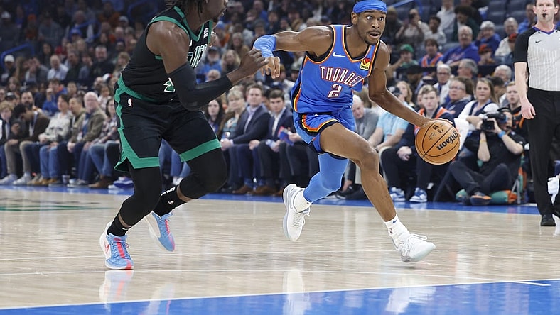 Jan 2, 2024; Oklahoma City, Oklahoma, USA; Oklahoma City Thunder guard Shai Gilgeous-Alexander (2) drives to the basket beside Boston Celtics guard Jrue Holiday (4) during the first quarter at Paycom Center. Mandatory Credit: Alonzo Adams-USA TODAY Sports