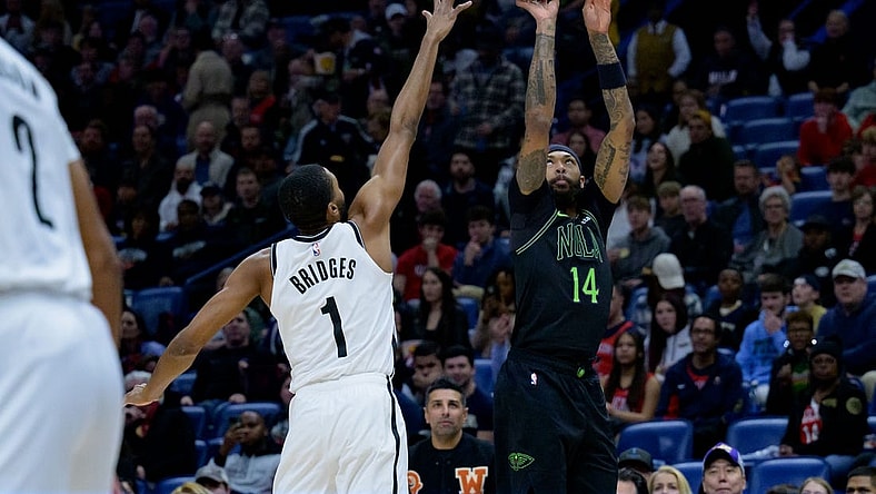 Jan 2, 2024; New Orleans, Louisiana, USA;  New Orleans Pelicans forward Brandon Ingram (14) shoots a three point basket against Brooklyn Nets forward Mikal Bridges (1) at Smoothie King Center. Mandatory Credit: Matthew Hinton-USA TODAY Sports