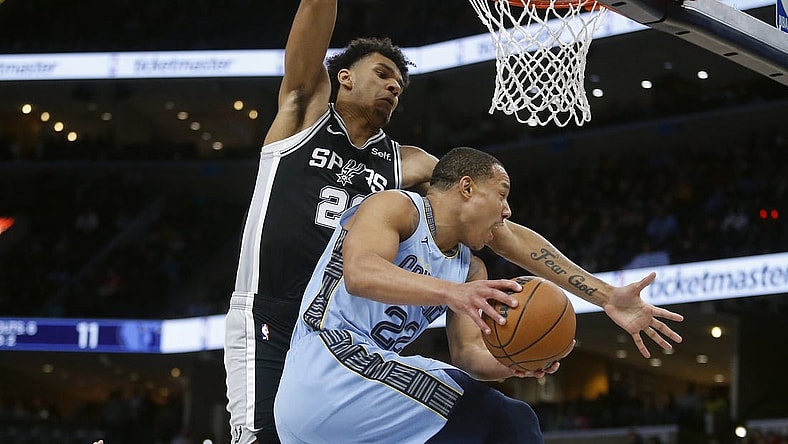 Jan 2, 2024; Memphis, Tennessee, USA; Memphis Grizzlies guard Desmond Bane (22) passes the ball as San Antonio Spurs forward Dominick Barlow (26) defends during the first half at FedExForum. Mandatory Credit: Petre Thomas-USA TODAY Sports