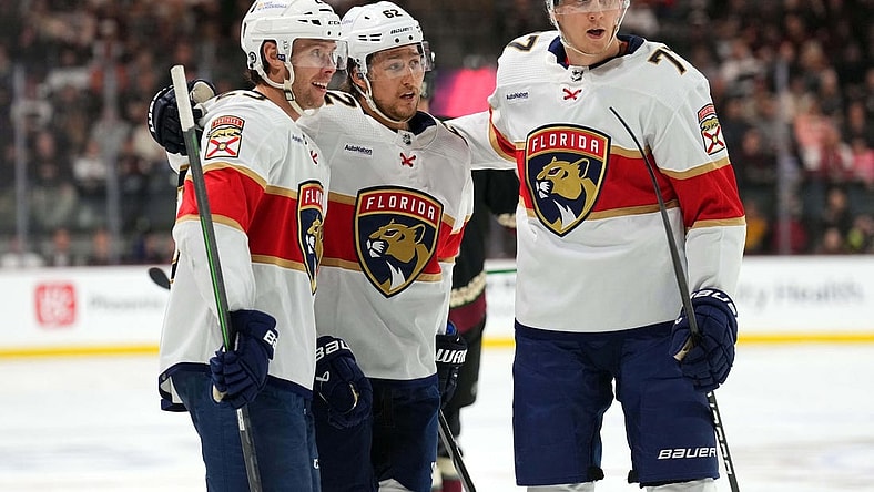 Jan 2, 2024; Tempe, Arizona, USA; Florida Panthers center Carter Verhaeghe (23) celebrates his goal with Florida Panthers defenseman Brandon Montour (62) and Florida Panthers defenseman Niko Mikkola (77) against the Arizona Coyotes during the first period at Mullett Arena. Mandatory Credit: Joe Camporeale-USA TODAY Sports