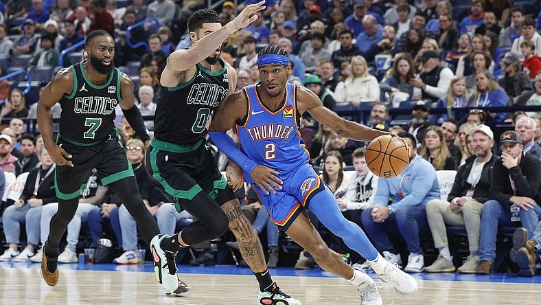 Jan 2, 2024; Oklahoma City, Oklahoma, USA; Oklahoma City Thunder guard Shai Gilgeous-Alexander (2) drives to the basket against Boston Celtics forward Jayson Tatum (0) during the second quarter at Paycom Center. Mandatory Credit: Alonzo Adams-USA TODAY Sports