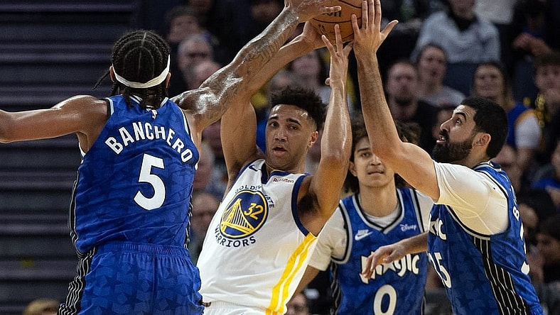 Jan 2, 2024; San Francisco, California, USA; Golden State Warriors forward Trayce Jackson-Davis (32) looks to pass away from defensive pressure from Orlando Magic players during the second quarter at Chase Center. Mandatory Credit: D. Ross Cameron-USA TODAY Sports