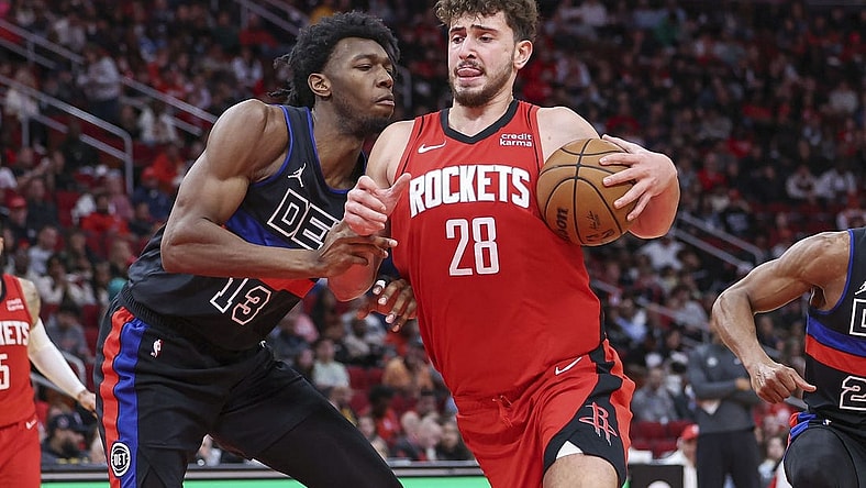 Jan 1, 2024; Houston, Texas, USA; Houston Rockets center Alperen Sengun (28) controls the ball as Detroit Pistons center James Wiseman (13) defends during the game at Toyota Center. Mandatory Credit: Troy Taormina-USA TODAY Sports