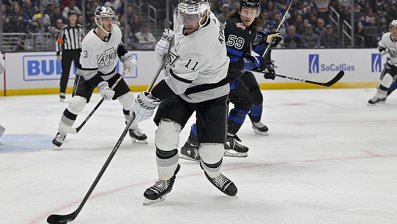 Jan 2, 2024; Los Angeles, California, USA; Los Angeles Kings center Anze Kopitar (11) keeps the puck from Toronto Maple Leafs left wing Tyler Bertuzzi (59) in the first period at Crypto.com Arena. Mandatory Credit: Jayne Kamin-Oncea-USA TODAY Sports